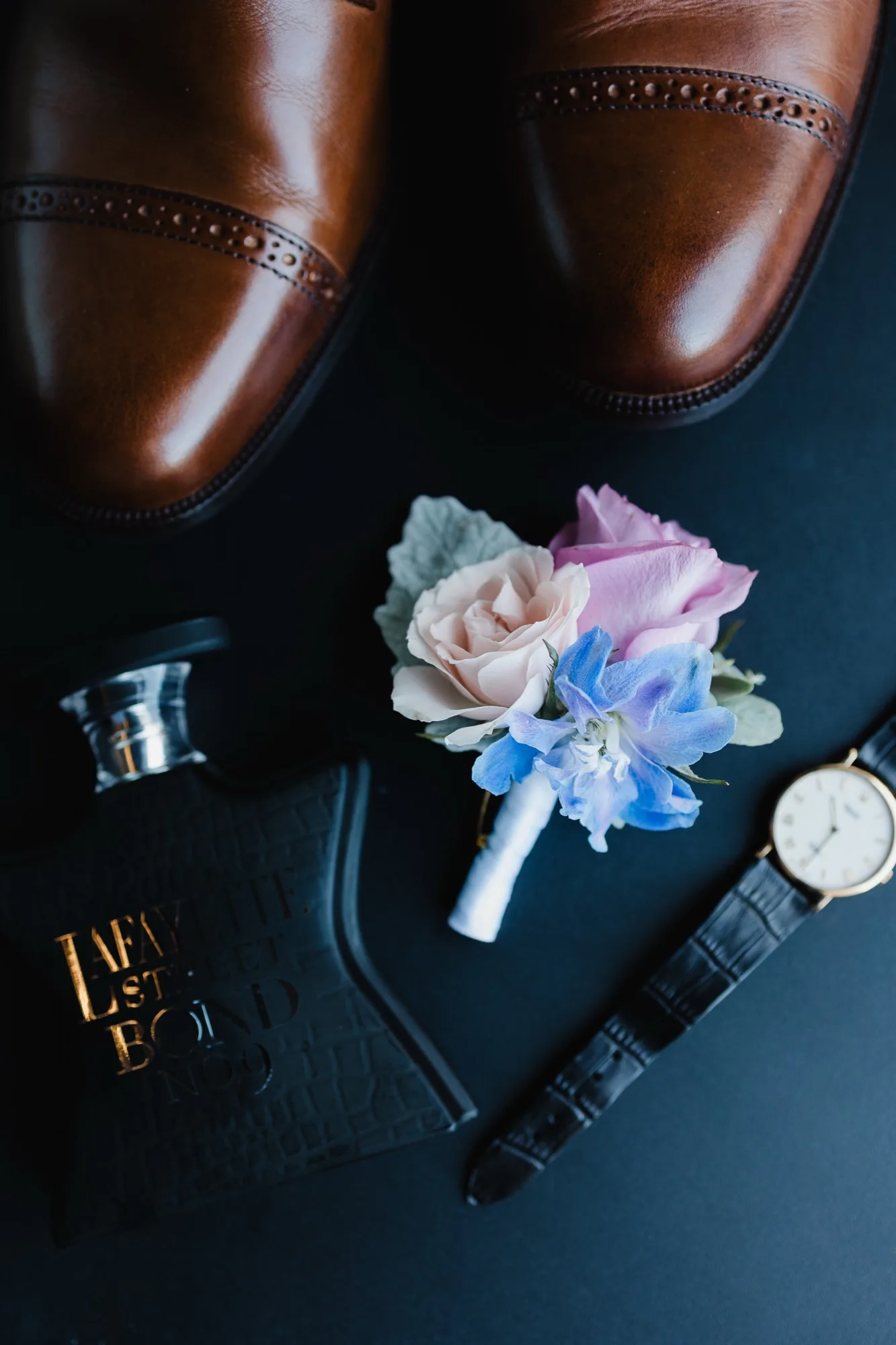 Pastel boutonnière with blush rose and delphinium